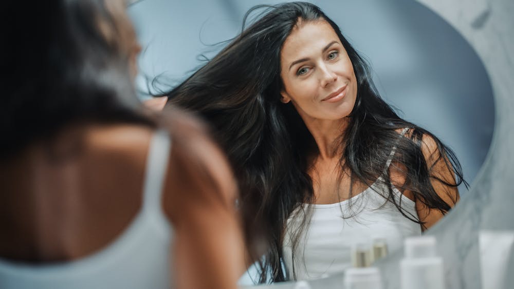 Woman looking at herself in a mirror