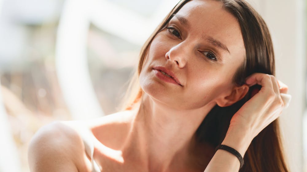 Woman tucking her hair behind her ear