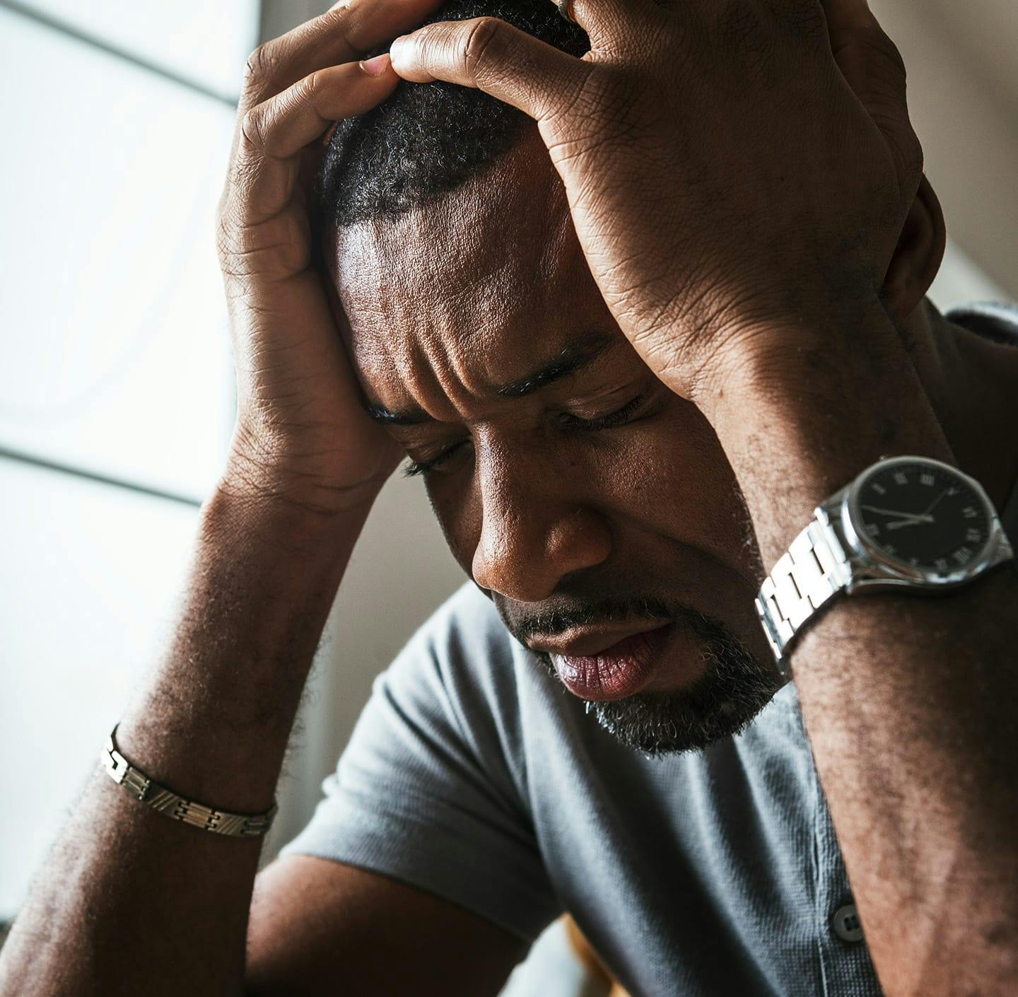 Man holding his head in his hands