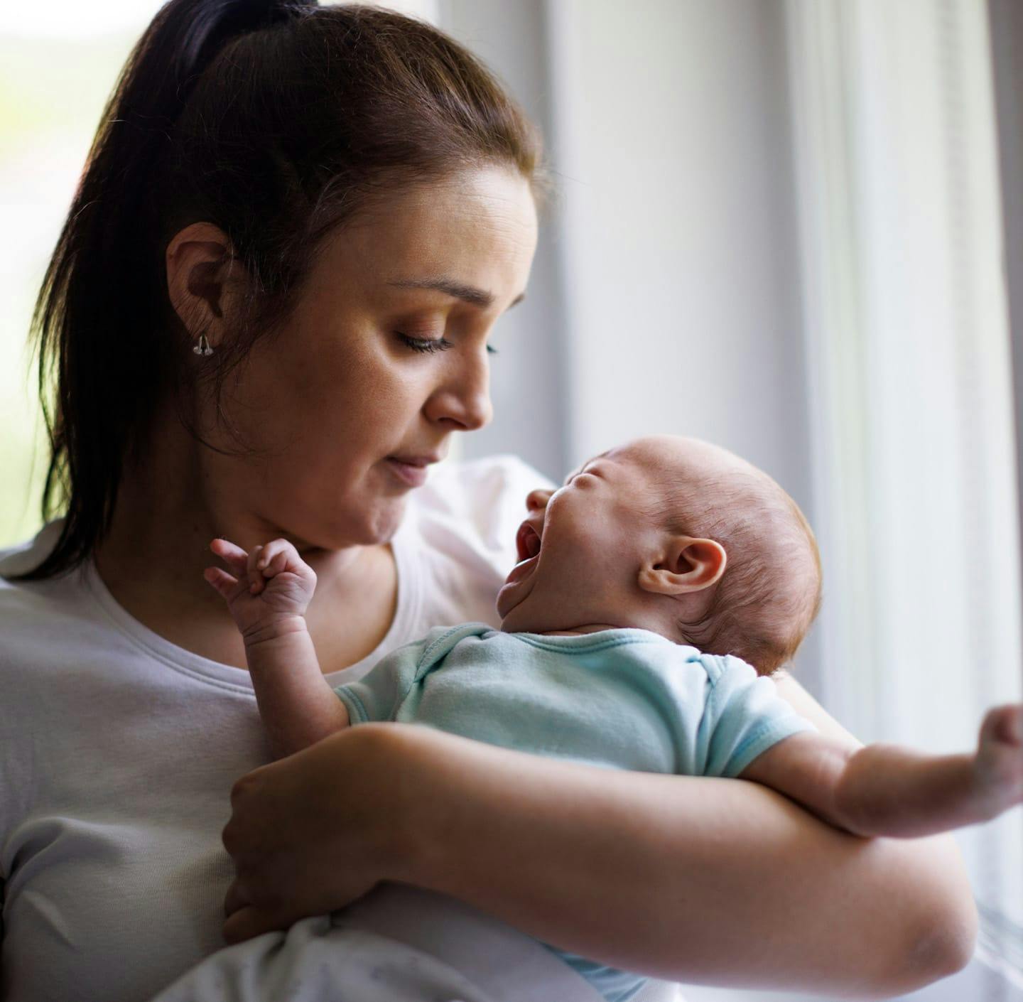 Woman holding crying baby