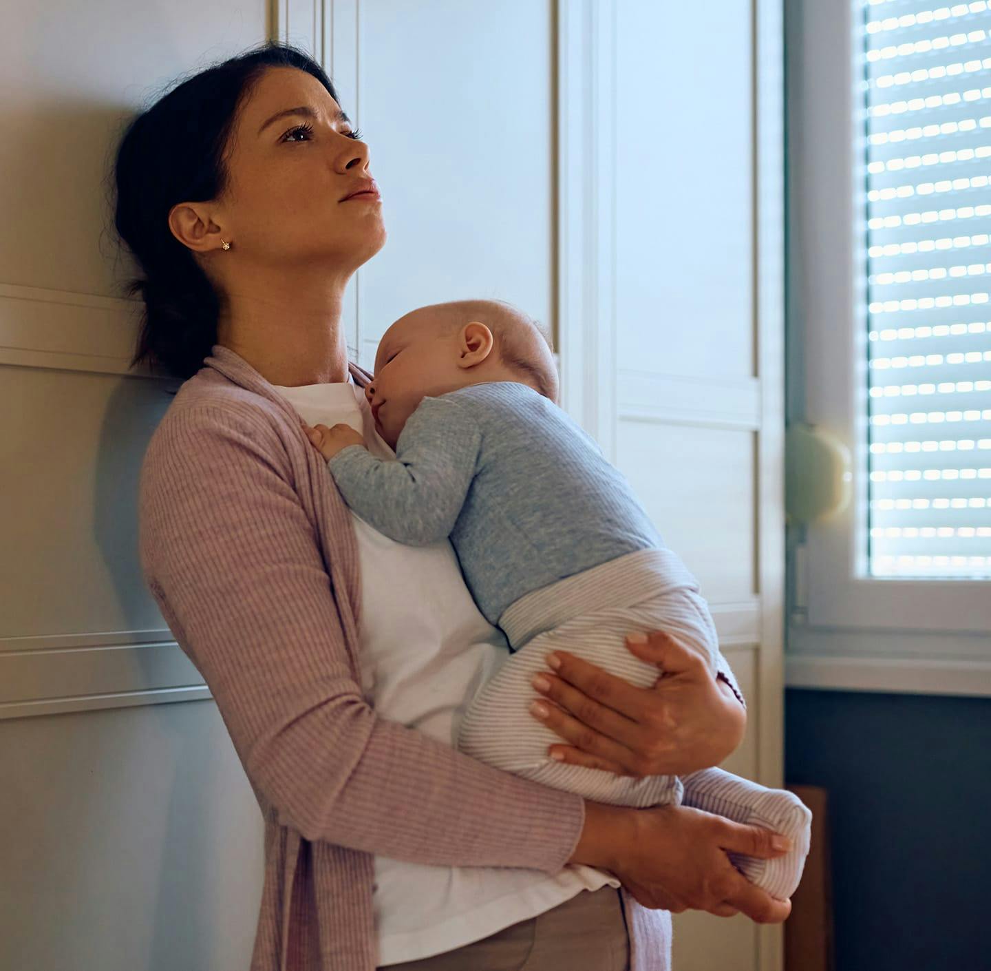 Woman holding sleeping baby