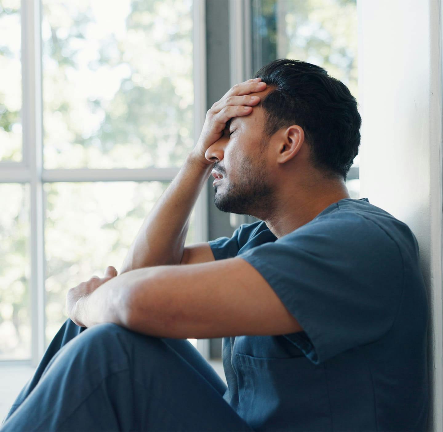 Win with face in his hand