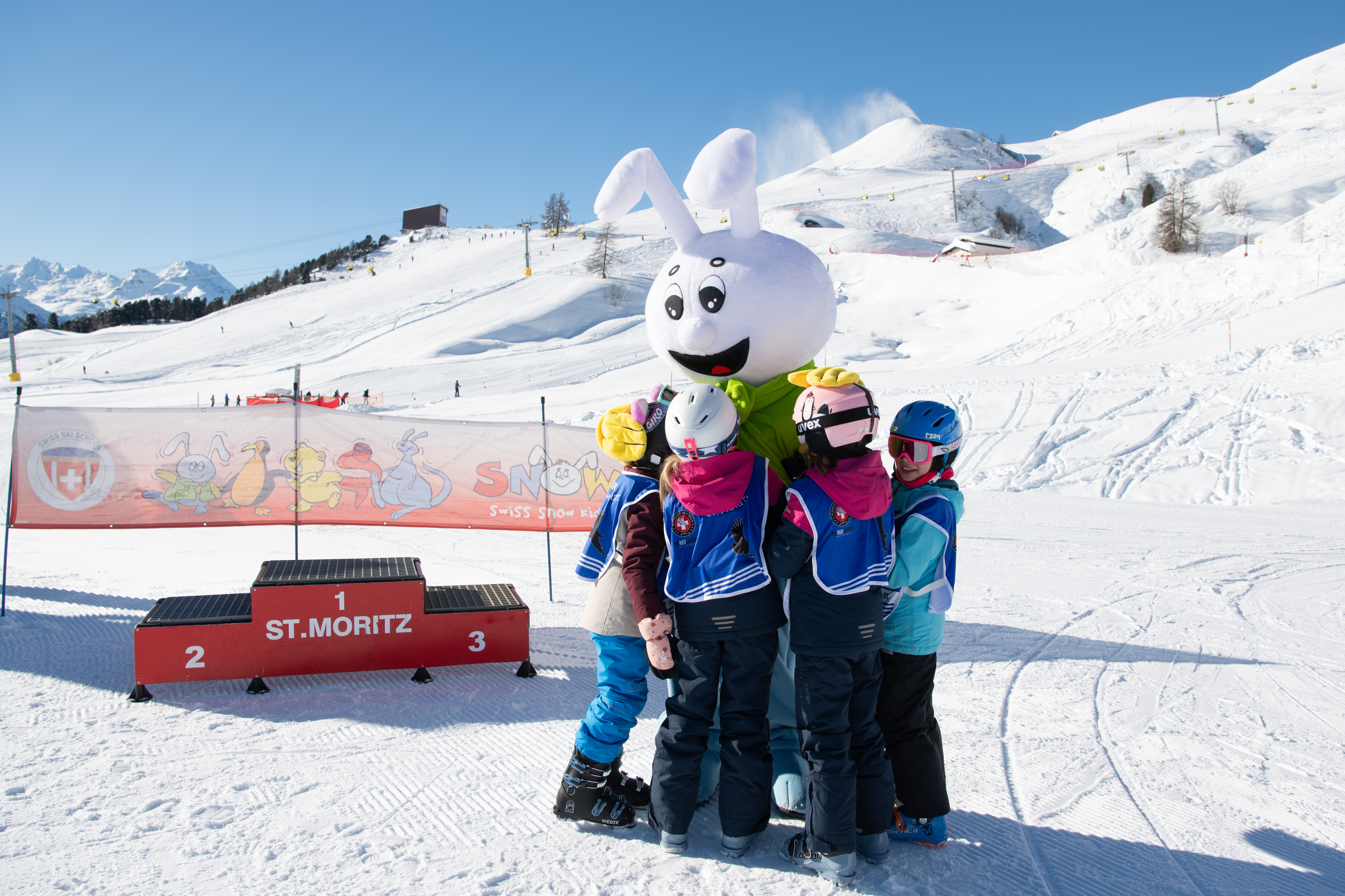 Snowli kids village kids hugging snowli