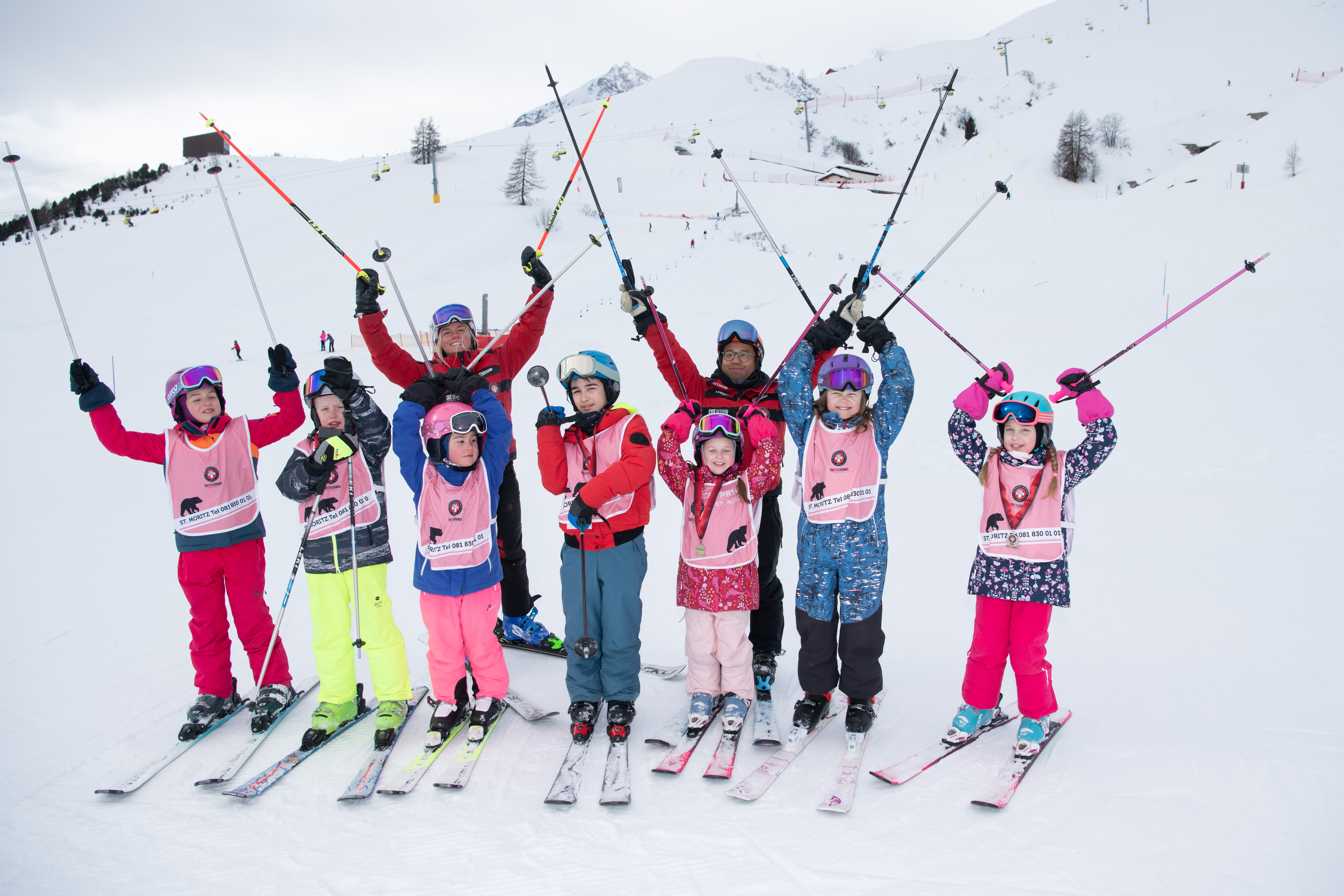 Children with skischool instructors on the slope