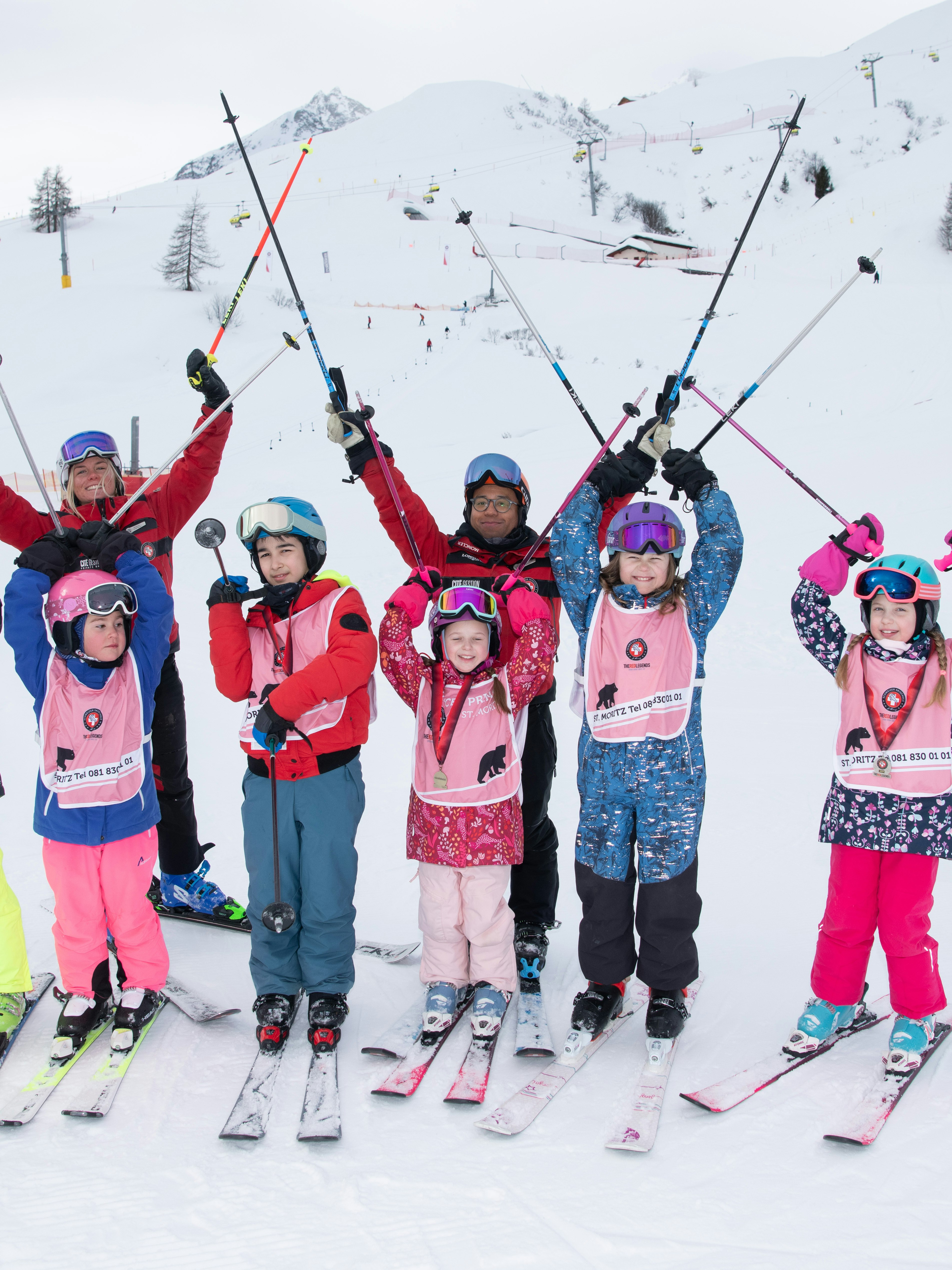 Children with skischool instructors on the slope