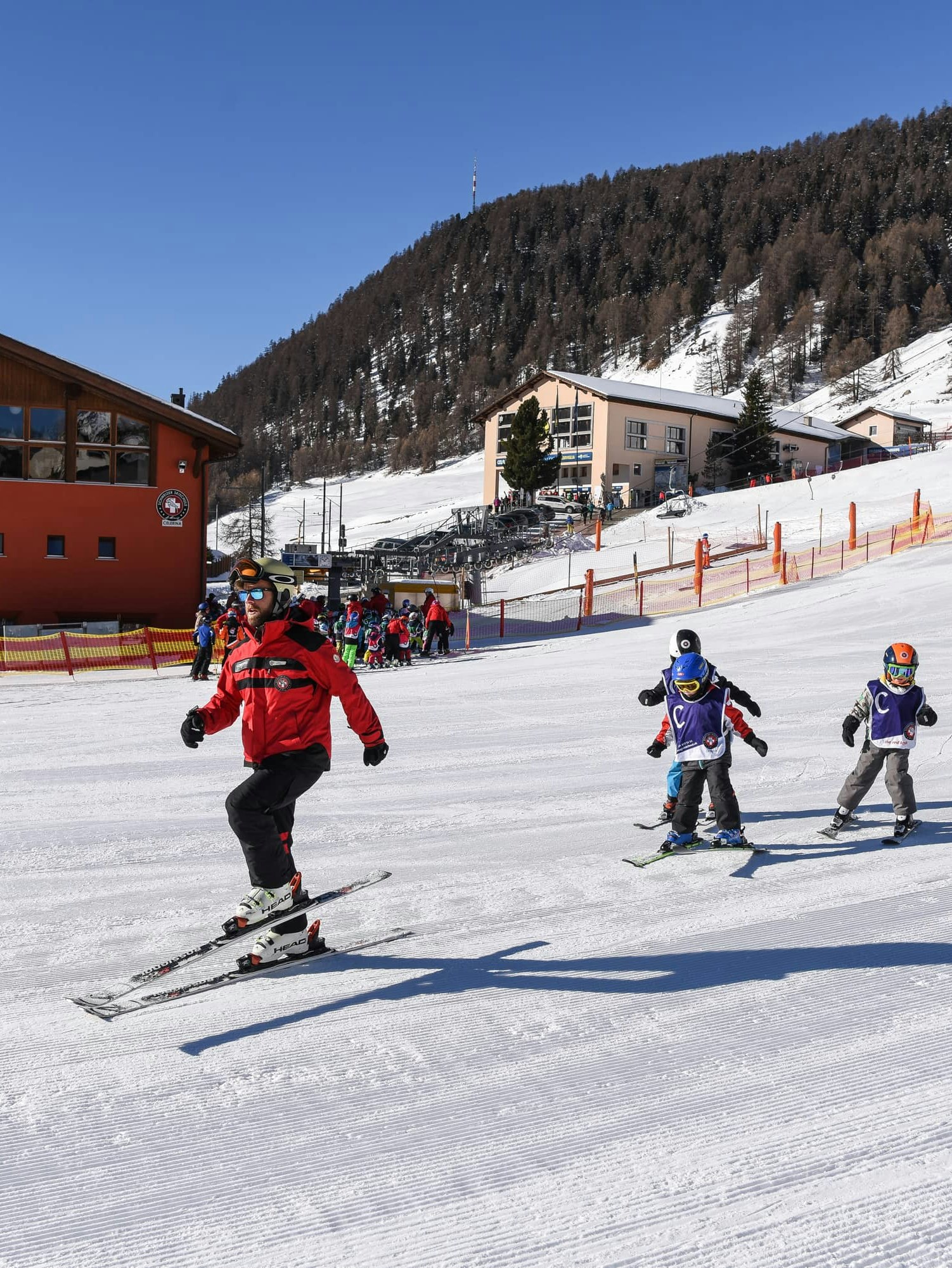 Ski class children wit swiss ski school St. Moritz instructor
