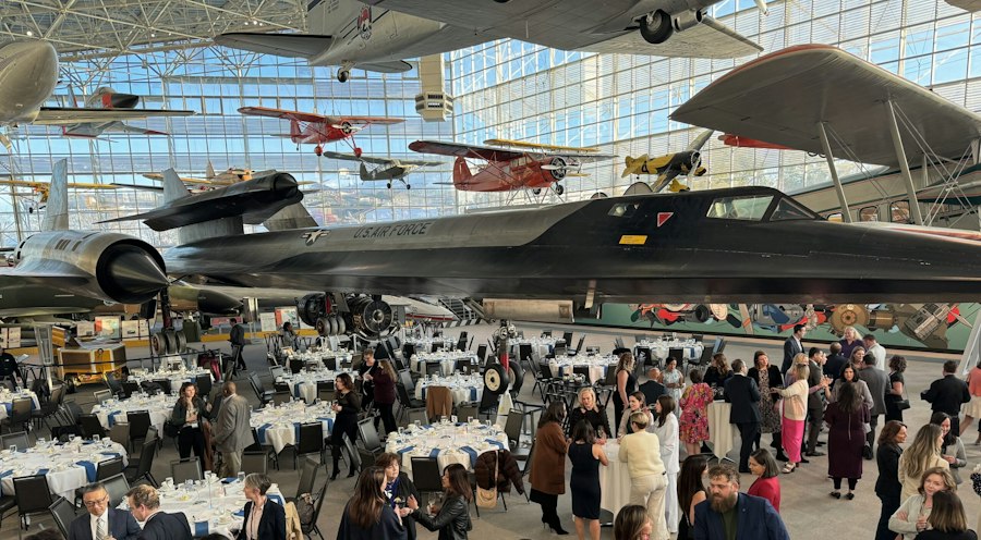 Members at a CSA dinner in an aircraft hangar