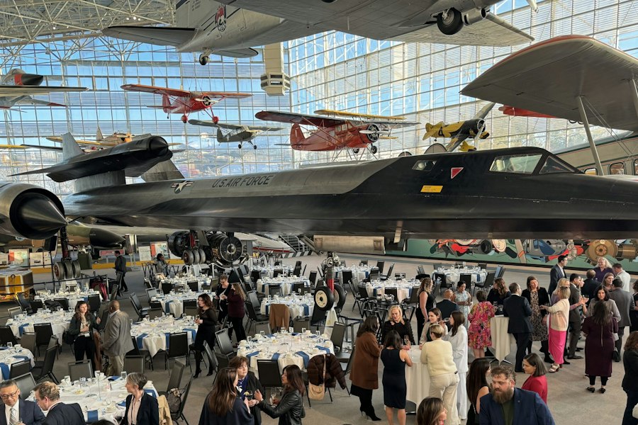 Members at a CSA dinner in an aircraft hangar