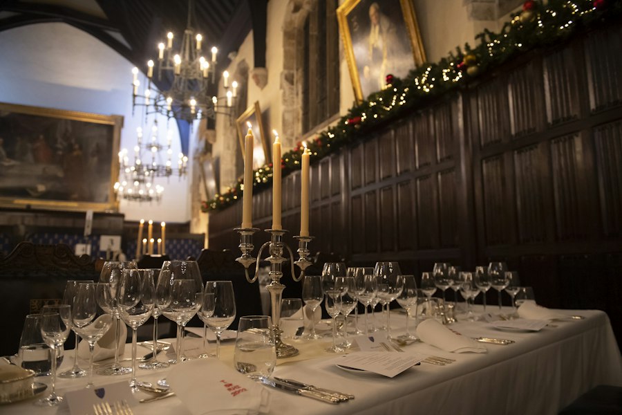 A candlelit dinner table set for a CSA event