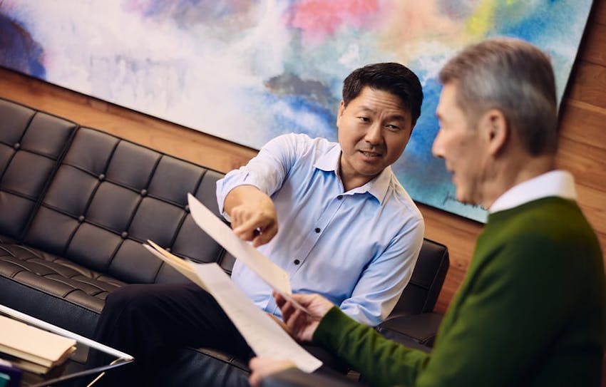 Rick pointing to paperwork while client looks at it