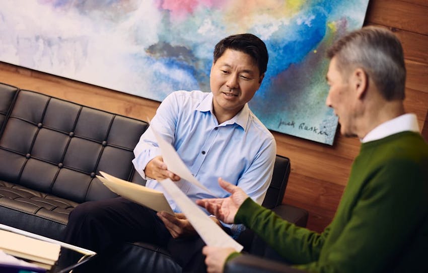 Rick handing forms to client