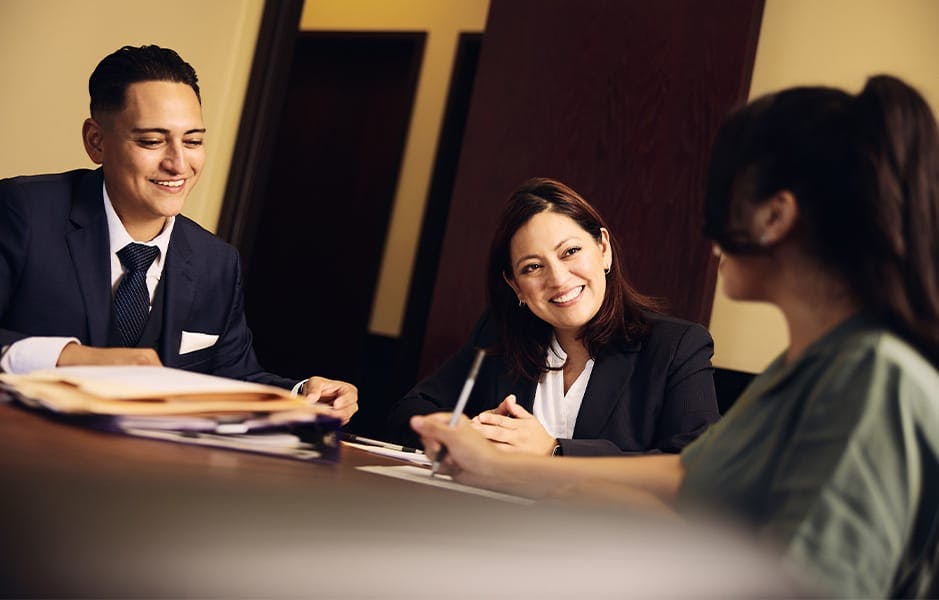 staff members sitting at table working on paperwork