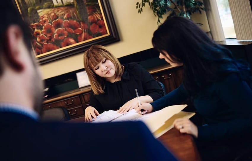 attorneys looking at folder together