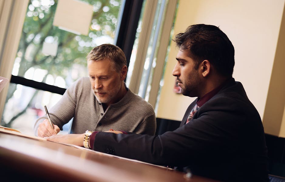 attorney and client filing paperwork next to eachother