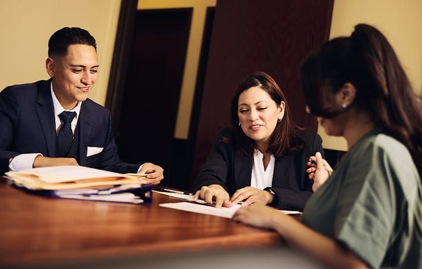 attorneys with client at table