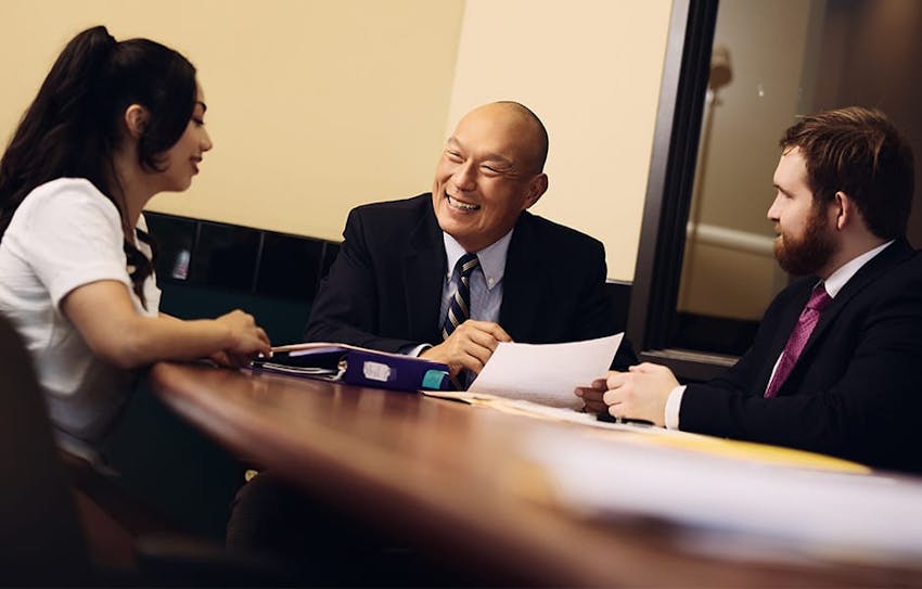 attorneys smiling and laughing with client