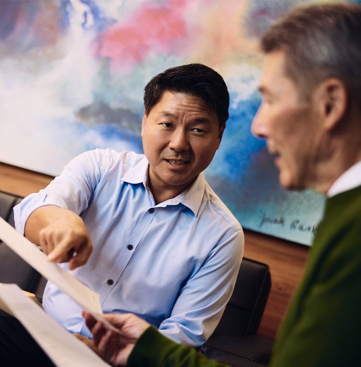 Rick pointing to paperwork to show client