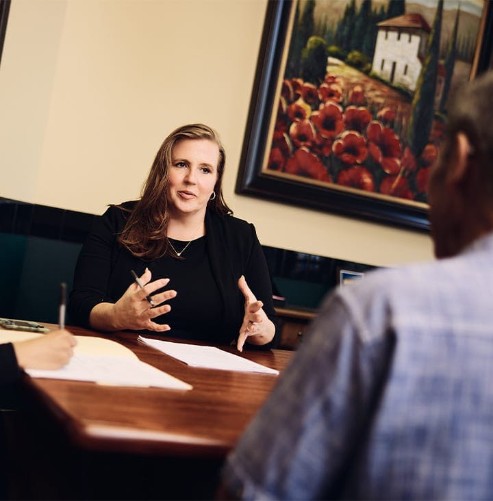 attorney across the table speaking to client