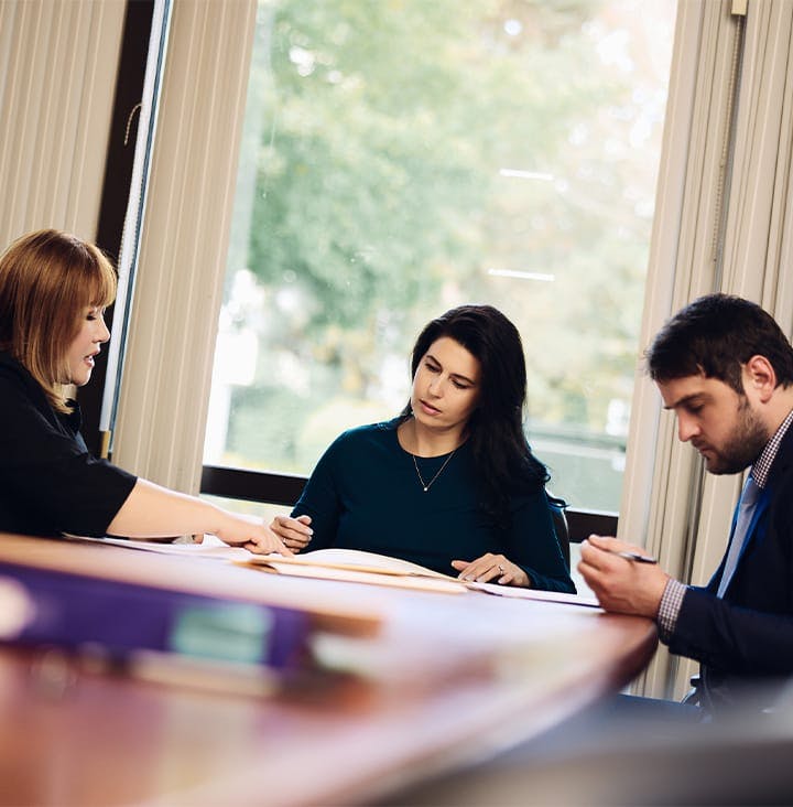 attorneys at table looking at forms together