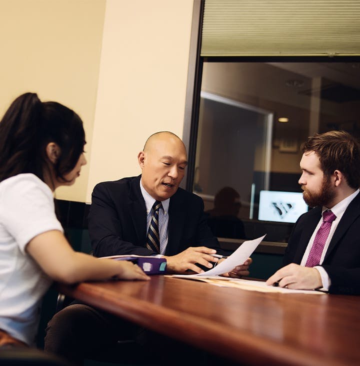 attorneys sitting with client