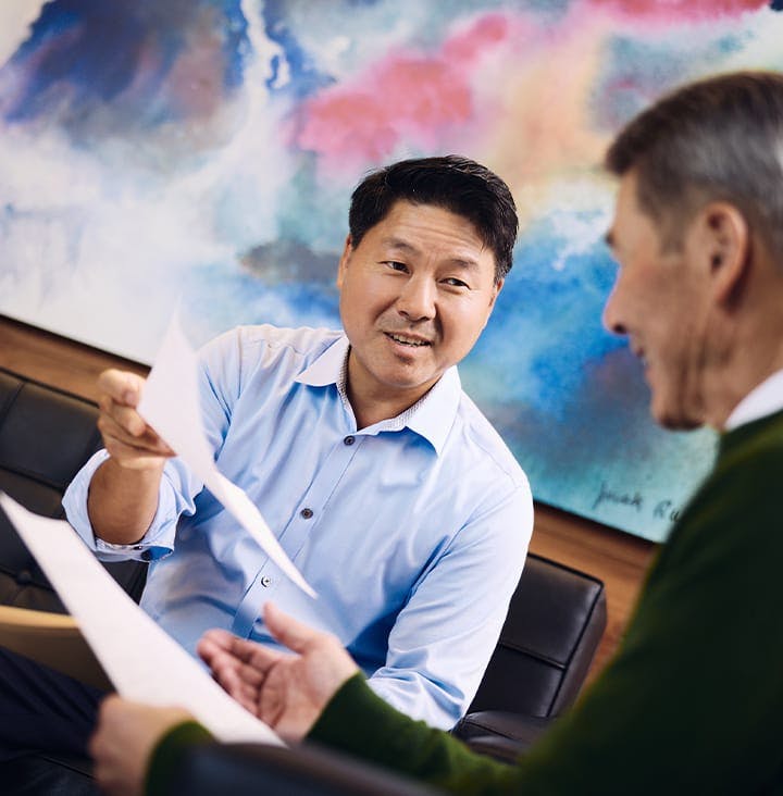 Rick Park handing paperwork to client