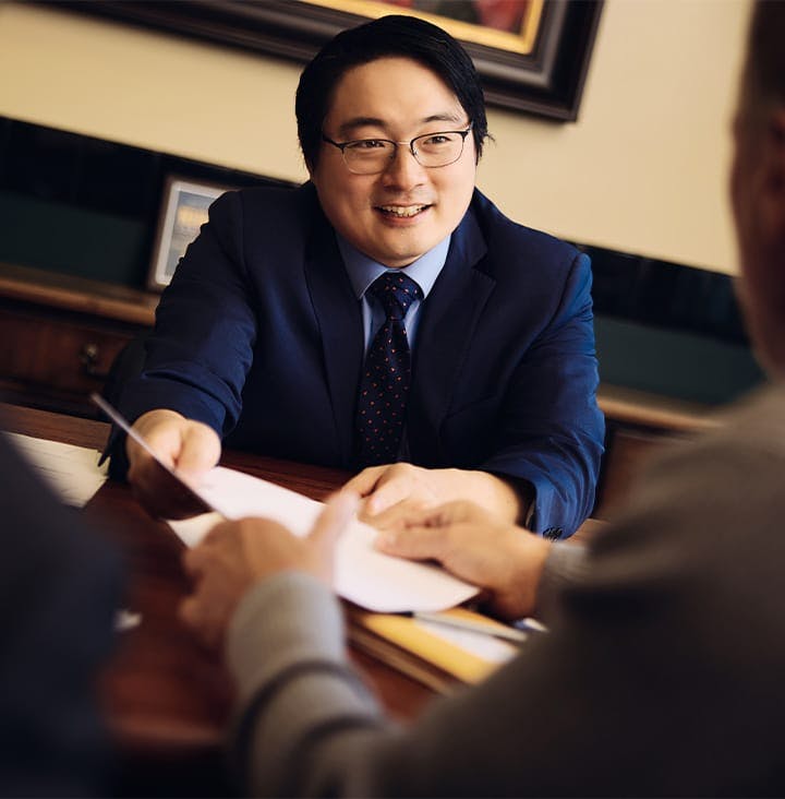 attorney handing paper to client