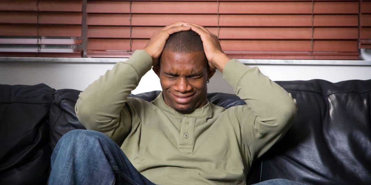 black male suffering from pain after car accident