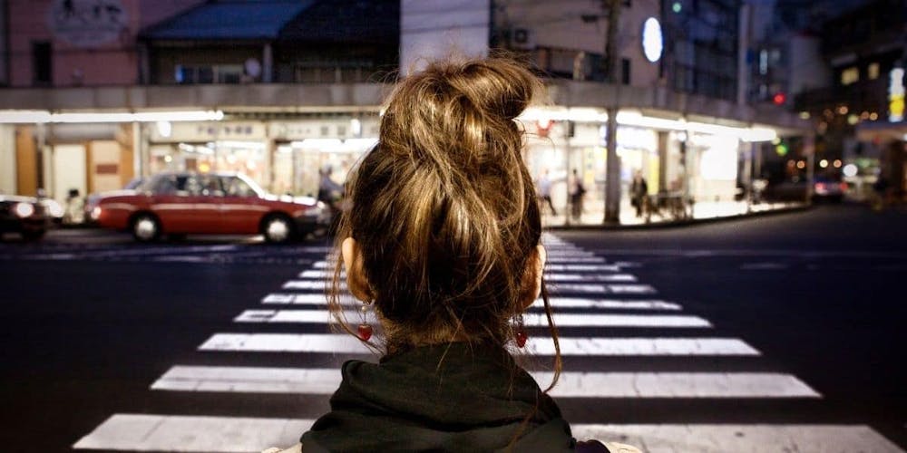 pedestrian waiting to cross crosswalk