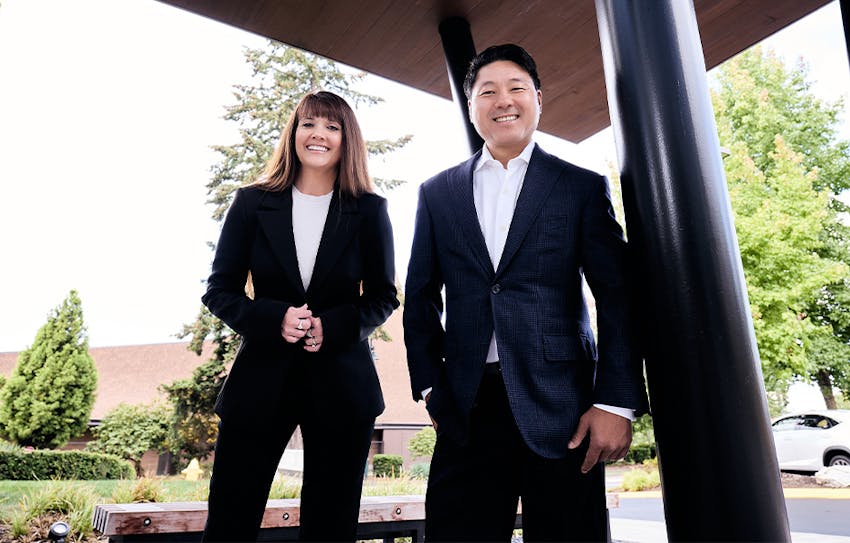 Angel and Rick standing together in suit