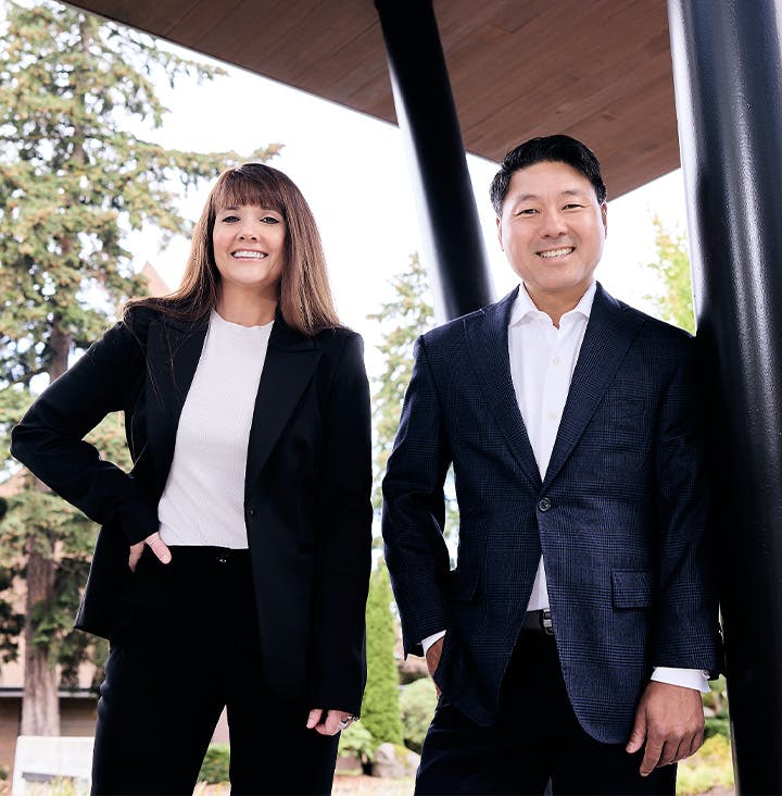 Rick and Angel standing in suits