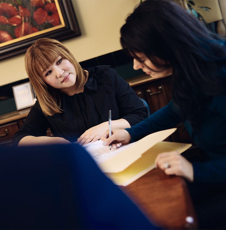 attorney writing in folder