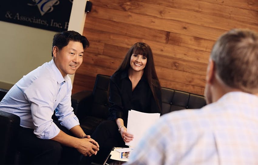 Rick and Angel sitting with client