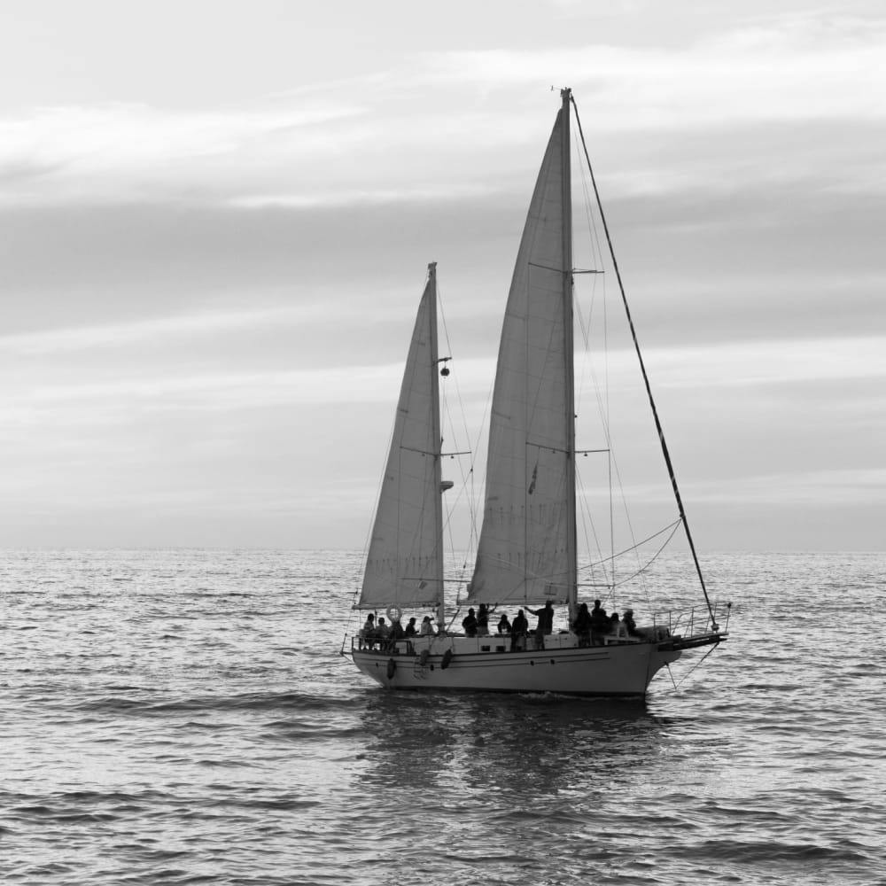 greyscale of small boat out at sea