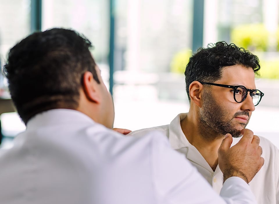 Dr. Chopra looking at patient's chin