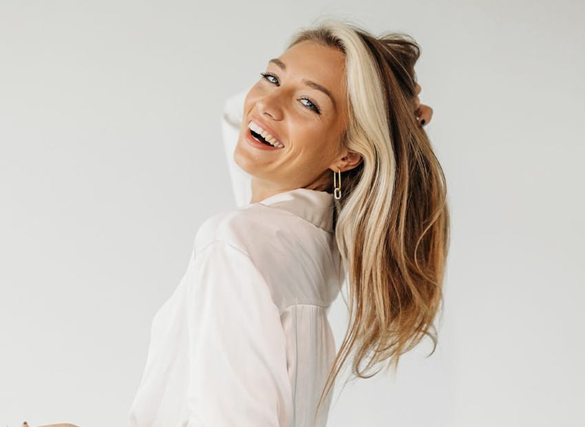 woman smiling leaning her head back