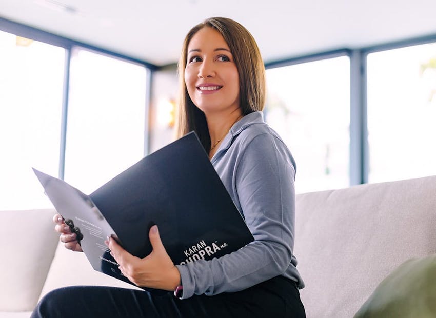woman in blue holding folder