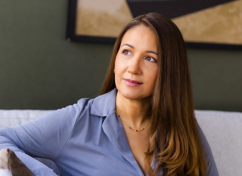 woman in blue sitting on couch