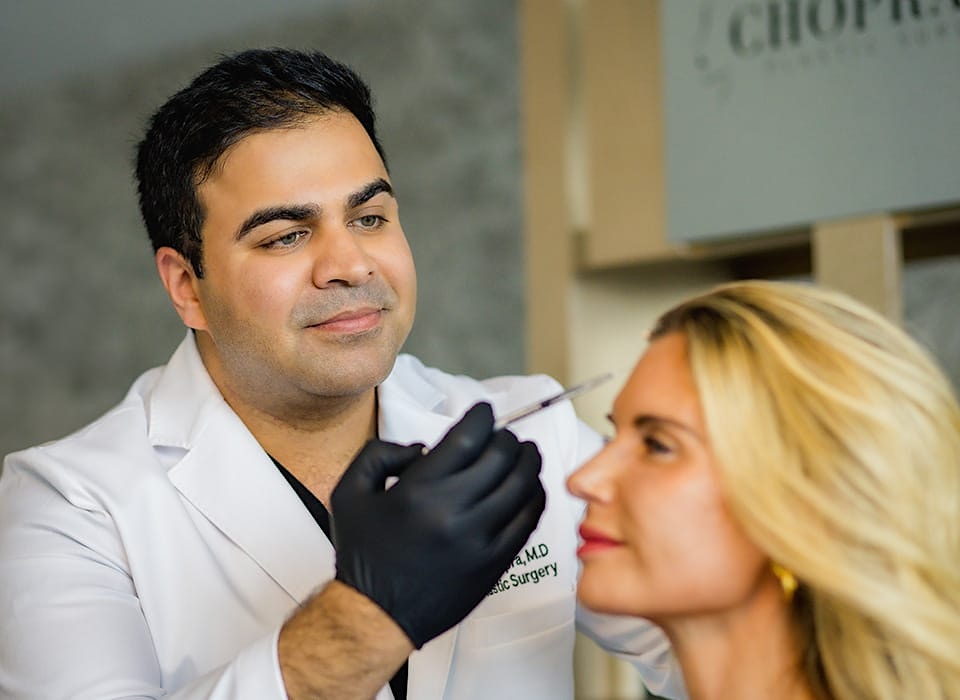 Dr. Chopra injecting into patient's forehead