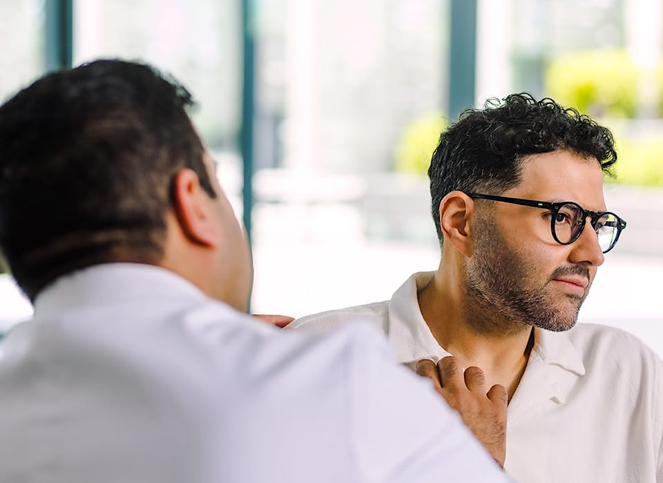 Dr. Chopra looking at side of patient's face