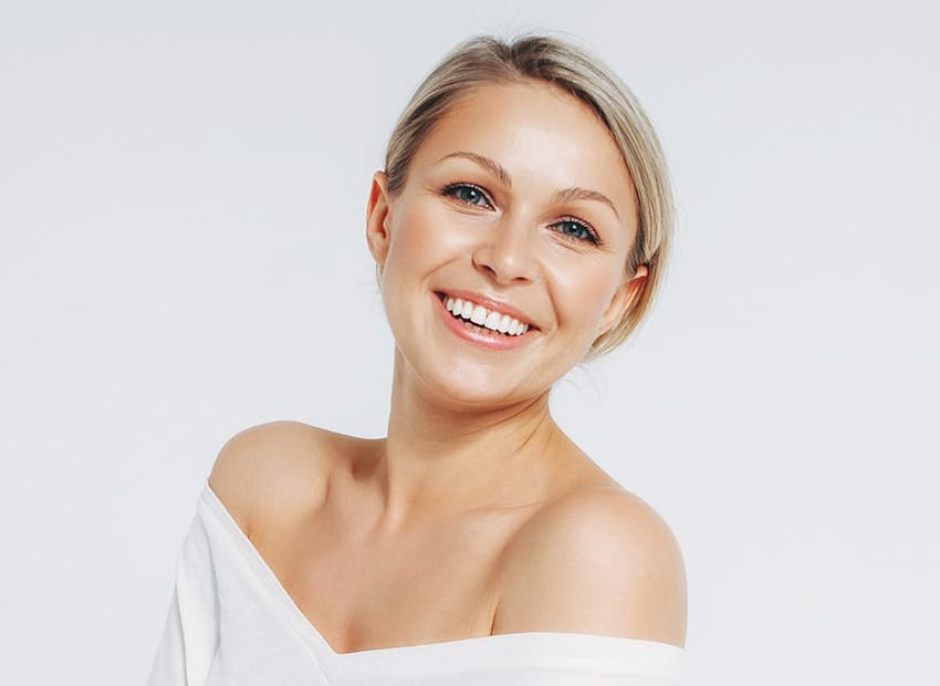 woman with hair pulled back in white top
