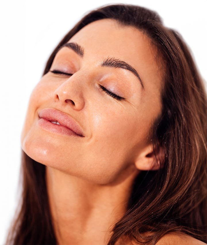 woman with eyes closed facing her head upwards