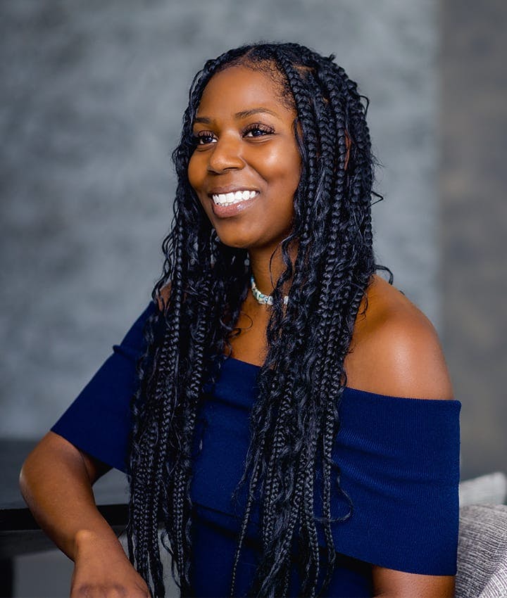woman smiling and sitting in chair