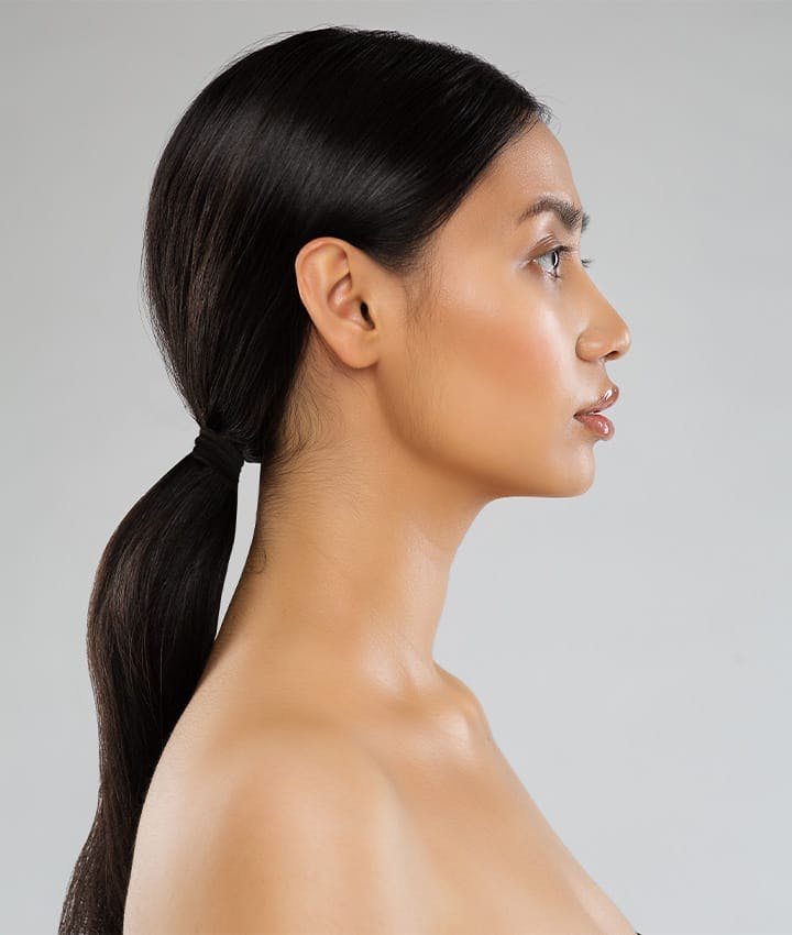 side profile of woman with long low ponytail