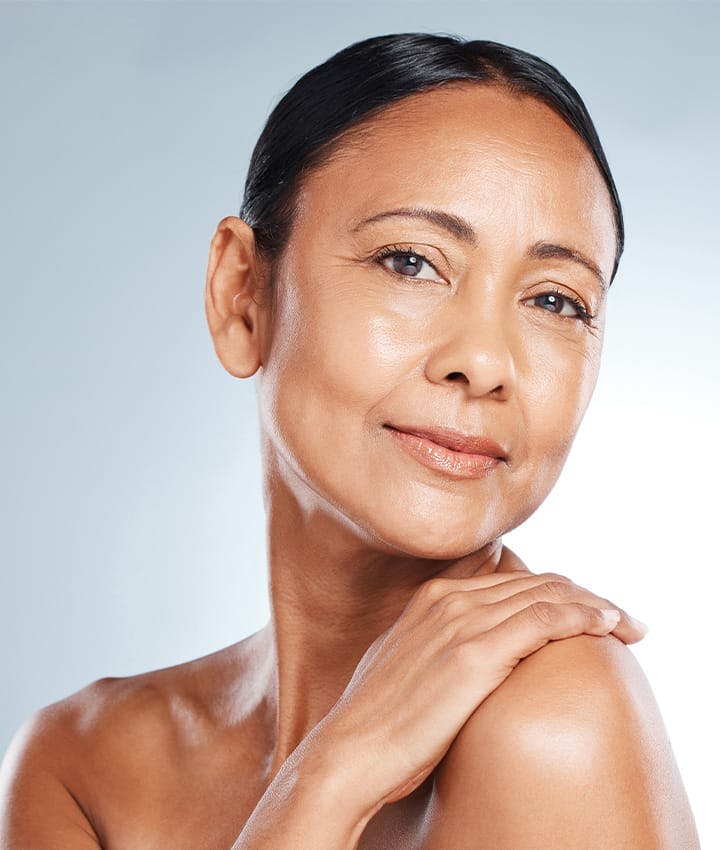 woman tilting head and touching her shoulder