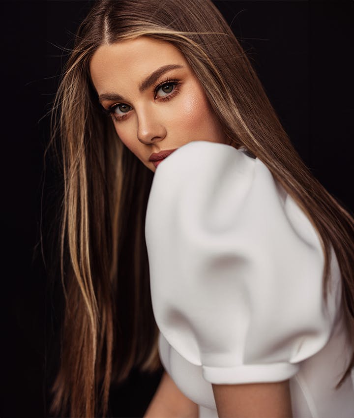 woman wearing a white top with puffy shoulders