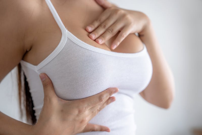 Woman touching her breast