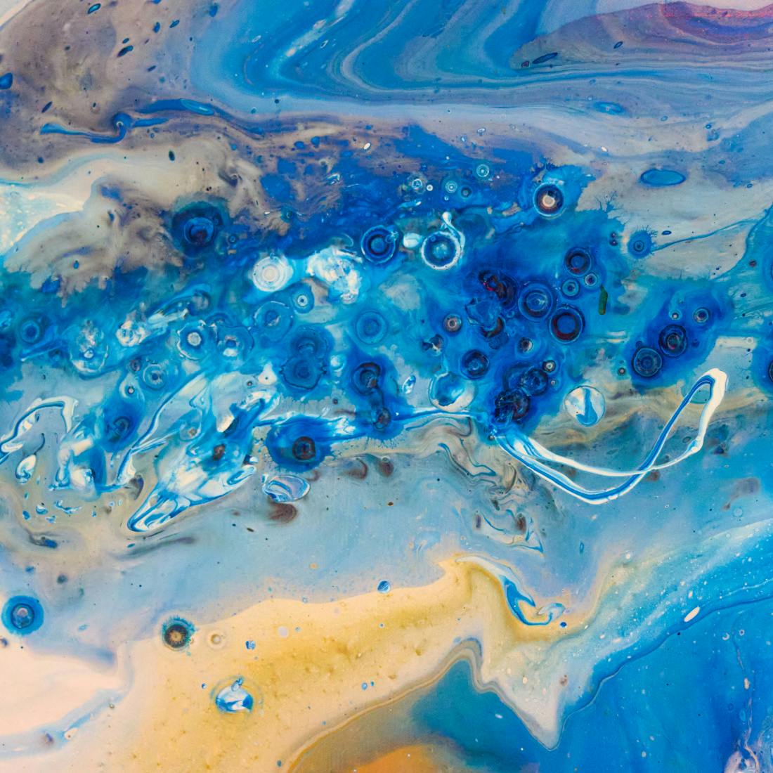 blue and yellow paint mixing together