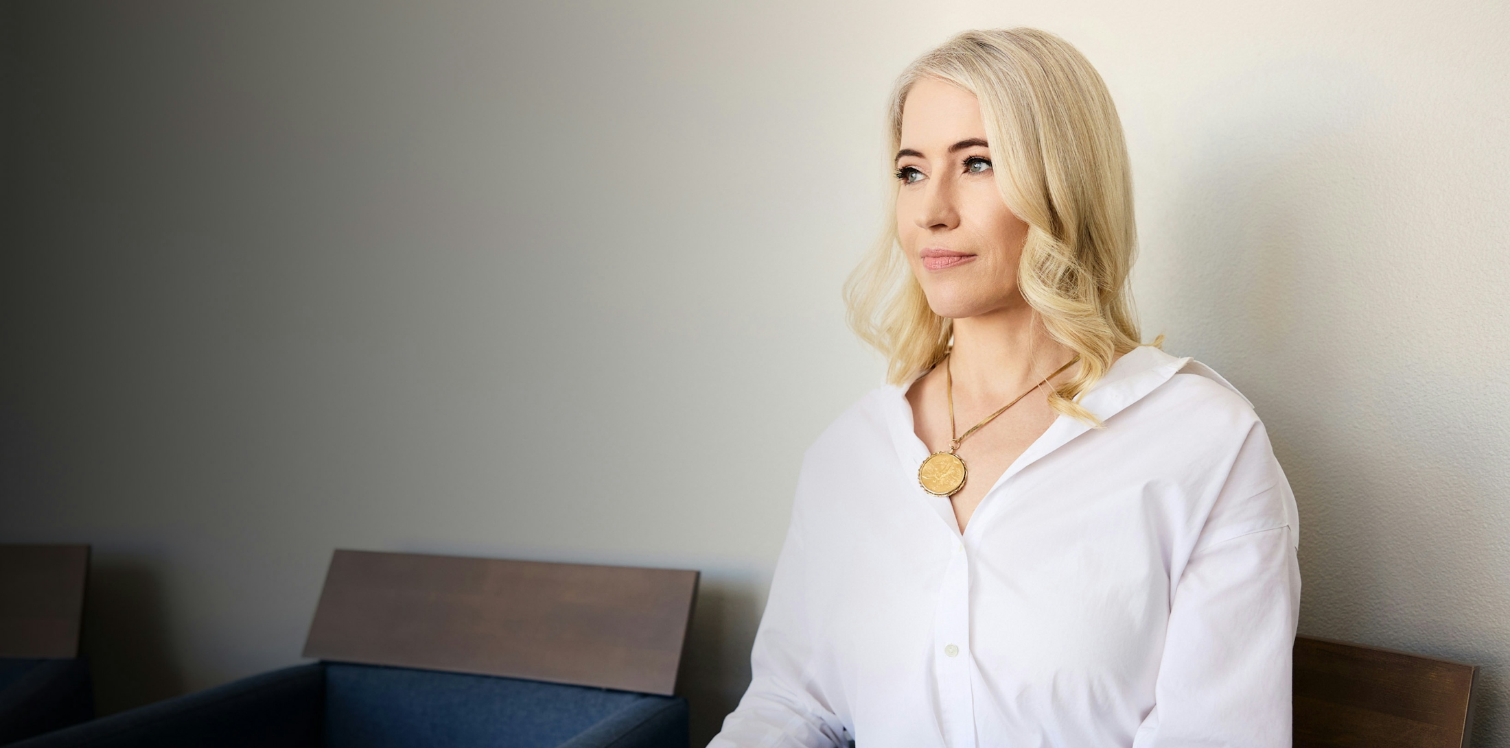 woman with blonde hair wearing a white button up shirt