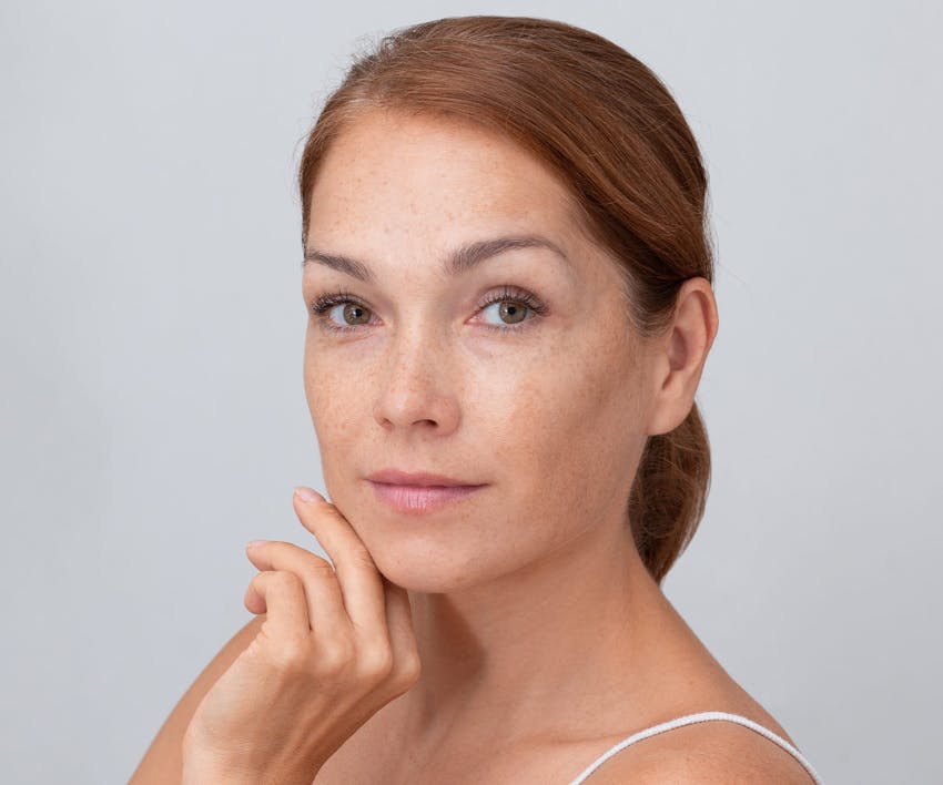 woman touching her hand on her chin