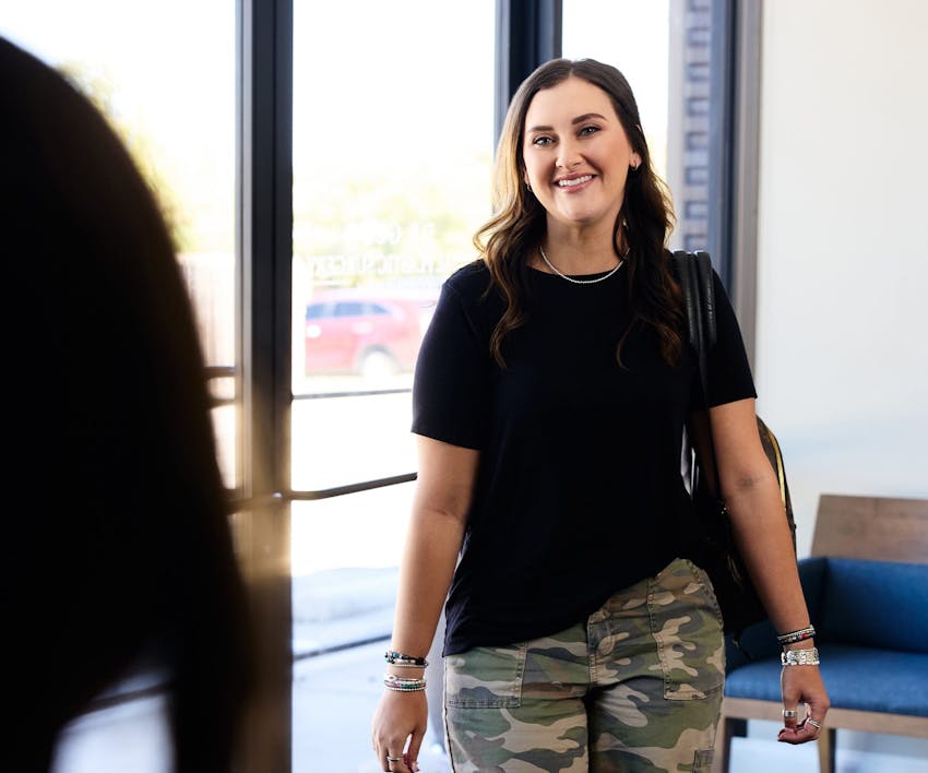 woman smiling walking into waiting room